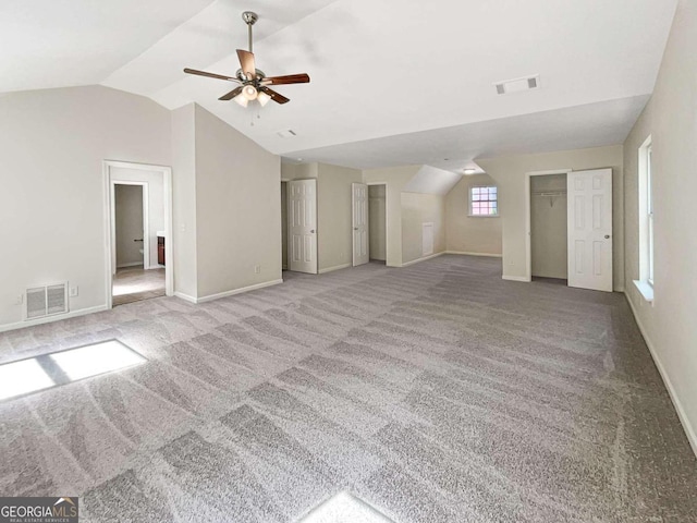 unfurnished living room with carpet floors, lofted ceiling, and ceiling fan