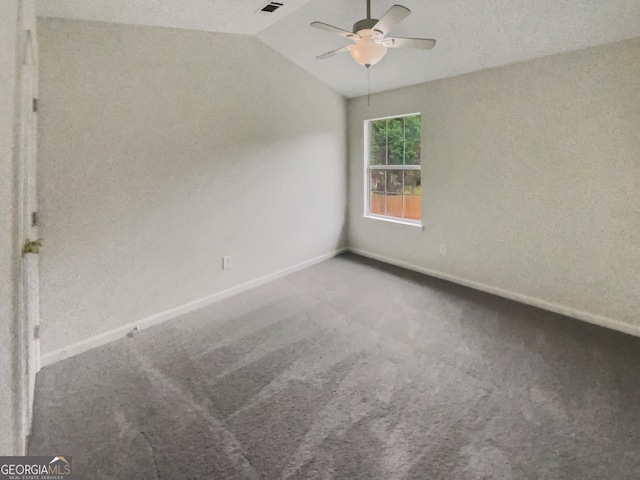 unfurnished bedroom featuring carpet, lofted ceiling, ceiling fan, and a textured ceiling