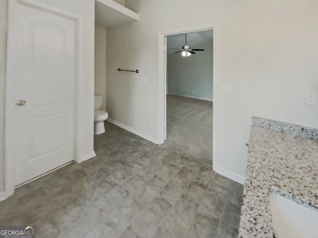 bathroom featuring ceiling fan and toilet