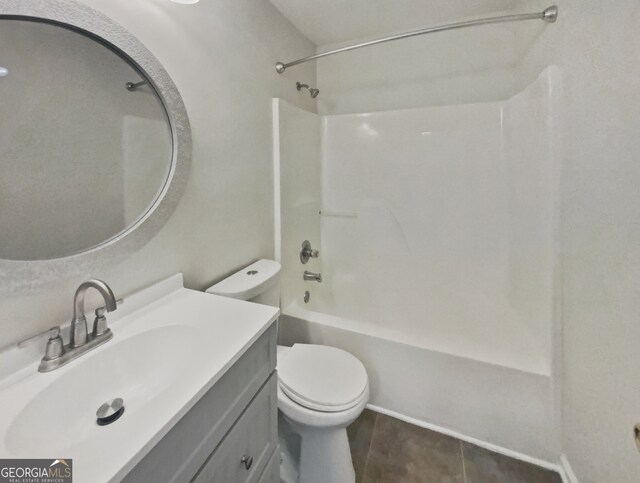 full bathroom with shower / washtub combination, vanity, toilet, and tile patterned floors