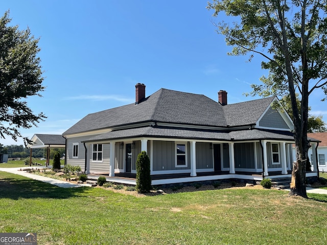 view of front of house featuring a sunroom and a front yard