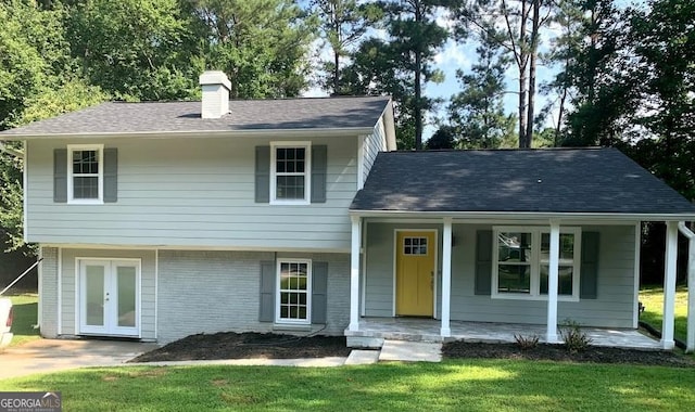 tri-level home featuring a front yard and french doors