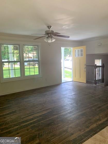 5364 Cedar Rock Dr, Stonecrest, GA 30038 - empty room featuring dark wood-type flooring, plenty of natural light, a ceiling fan, crown molding, and baseboards