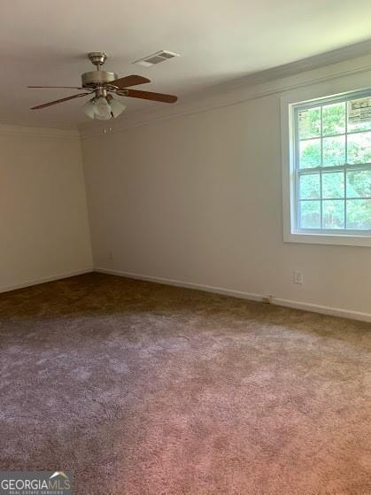 carpeted spare room featuring ceiling fan and ornamental molding