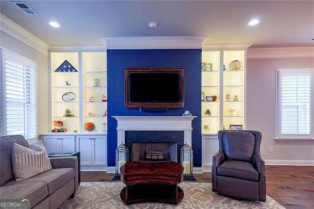 living room featuring ornamental molding and wood-type flooring