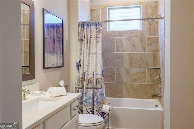 full bathroom with vanity, shower / tub combo with curtain, and toilet