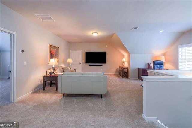 living room featuring light colored carpet and lofted ceiling