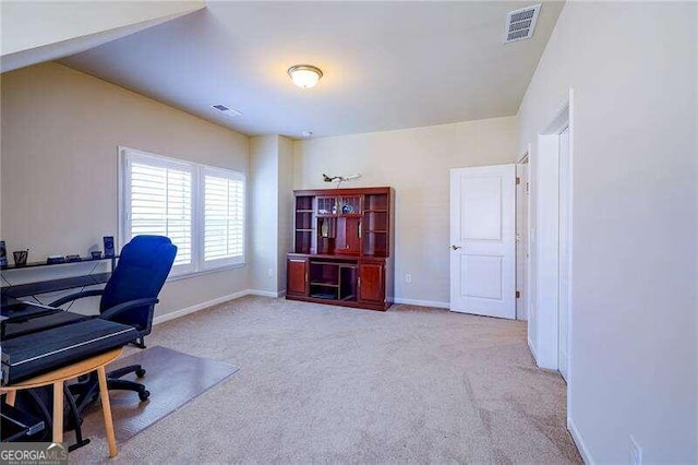 carpeted office with vaulted ceiling