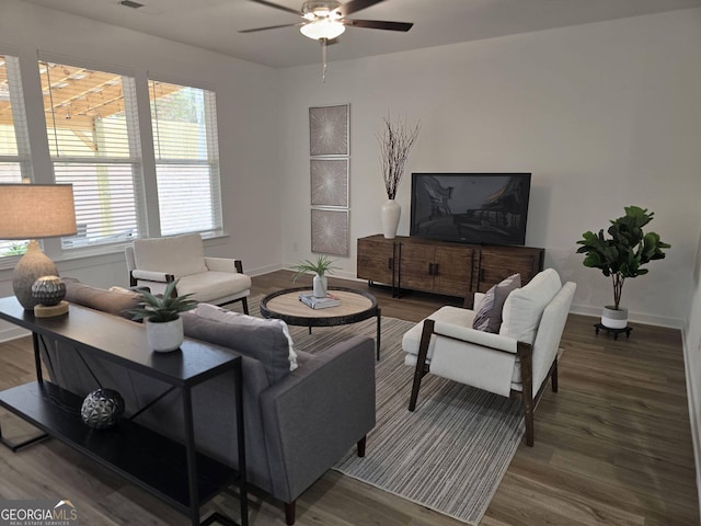 living room featuring wood-type flooring and ceiling fan