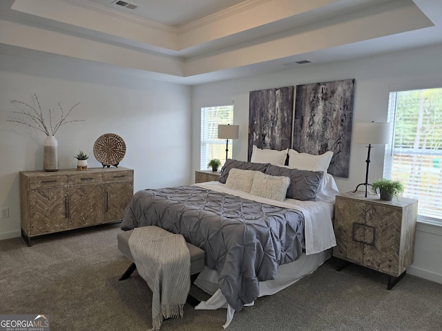 carpeted bedroom featuring multiple windows, crown molding, and a tray ceiling