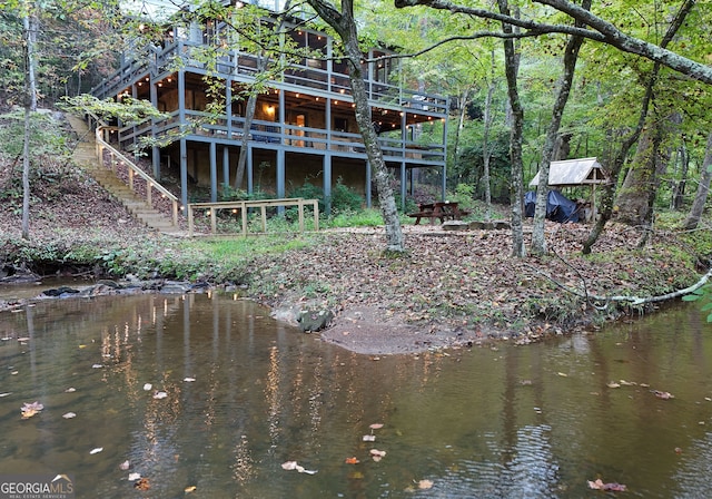 rear view of property with a water view