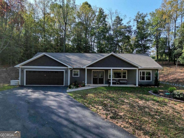 ranch-style home with a garage and covered porch