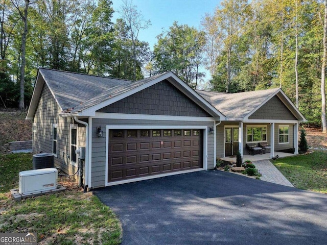 view of front of house with central AC unit and a garage