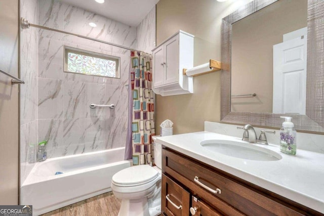 full bathroom with shower / tub combo, hardwood / wood-style floors, vanity, and toilet