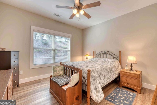 bedroom with light hardwood / wood-style flooring and ceiling fan