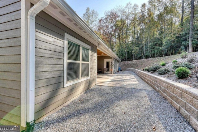 view of property exterior with a patio