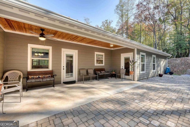 back of house with ceiling fan and a patio area