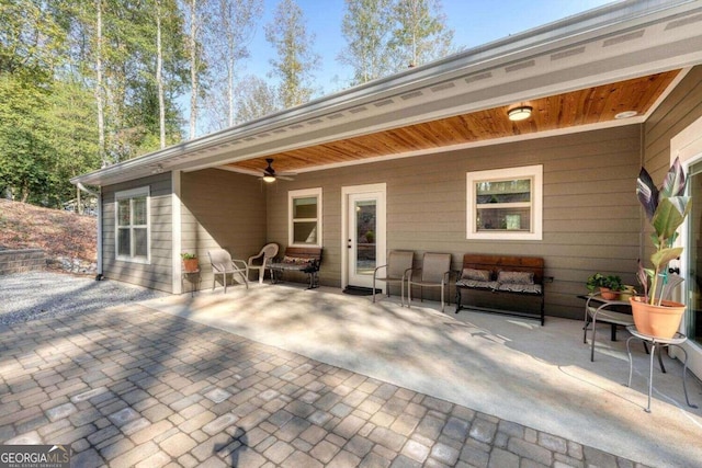 rear view of property with a patio and ceiling fan