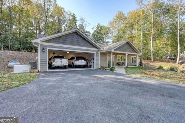 view of front of house featuring central AC unit and a garage