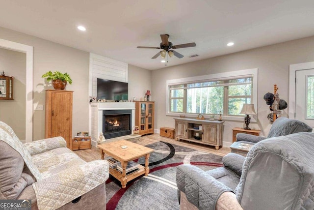 living room with ceiling fan and light wood-type flooring