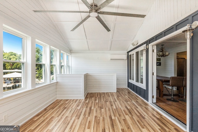 unfurnished sunroom featuring lofted ceiling and a wall mounted air conditioner