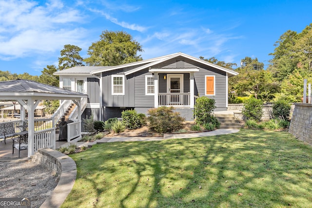 view of front of home with a gazebo and a front lawn