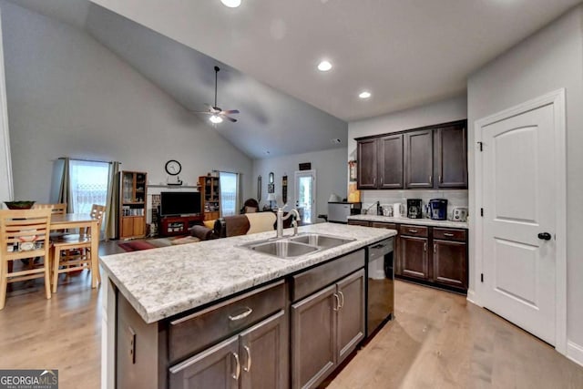 kitchen with an island with sink, light hardwood / wood-style flooring, ceiling fan, stainless steel dishwasher, and sink