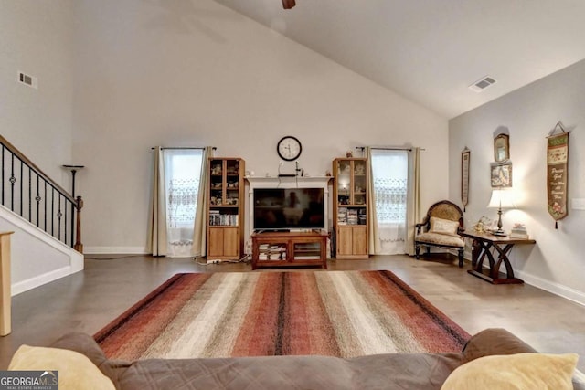 living room featuring ceiling fan, hardwood / wood-style flooring, and high vaulted ceiling