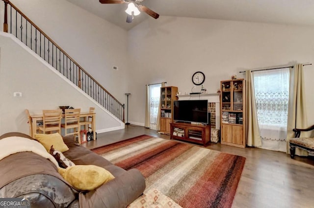 living room with high vaulted ceiling, ceiling fan, and hardwood / wood-style floors