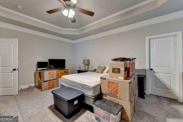 bedroom featuring light carpet, ceiling fan, a raised ceiling, and crown molding