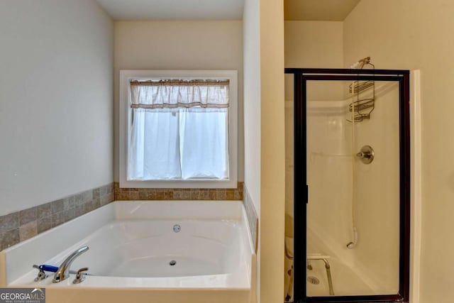 bathroom featuring independent shower and bath