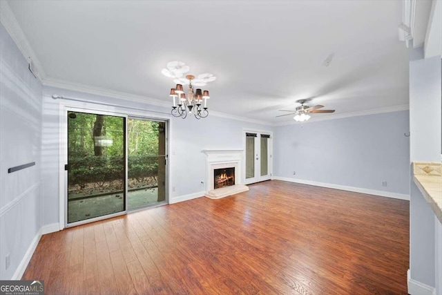 unfurnished living room with ornamental molding, dark hardwood / wood-style floors, ceiling fan, and plenty of natural light