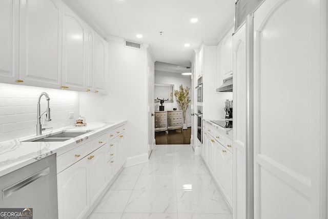 kitchen featuring sink, black electric cooktop, white cabinets, light stone counters, and decorative backsplash