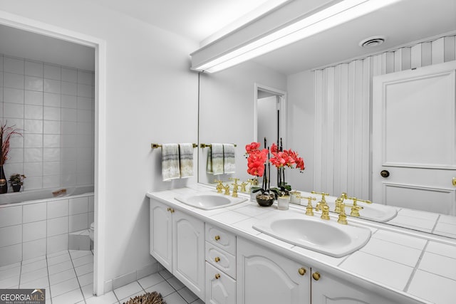 bathroom with vanity, tile patterned floors, and a bathtub