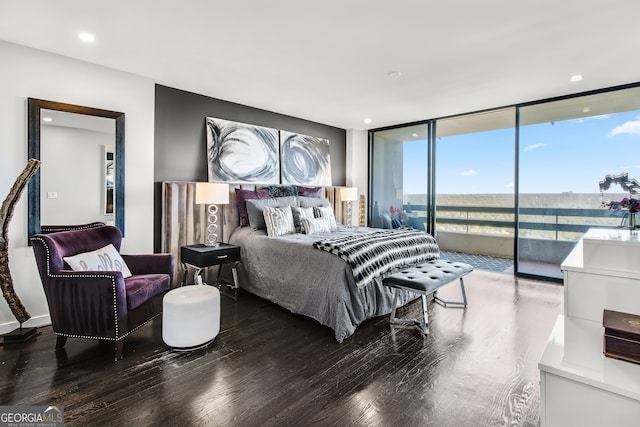 bedroom featuring access to outside, expansive windows, and hardwood / wood-style floors