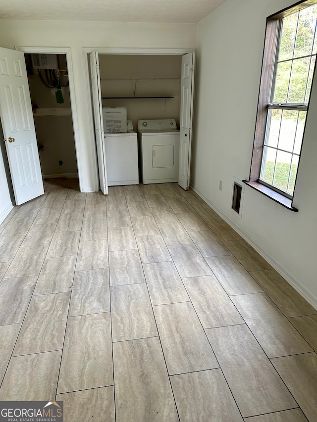 laundry area with washer and dryer and plenty of natural light