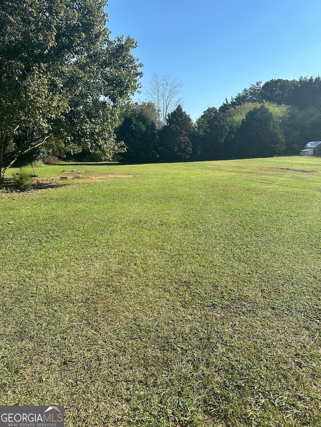 view of yard with a rural view