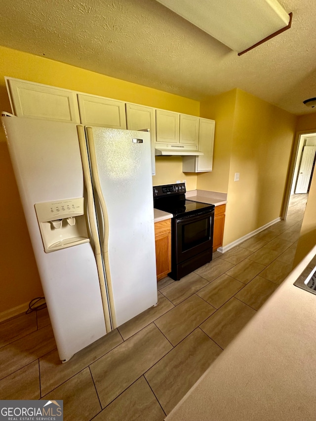 kitchen featuring black electric range, white fridge with ice dispenser, and a textured ceiling