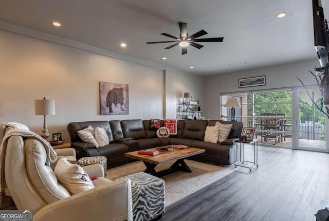 living room featuring ceiling fan and hardwood / wood-style flooring