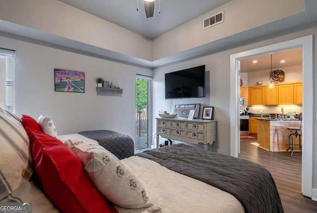 bedroom featuring ceiling fan, access to outside, and dark hardwood / wood-style flooring