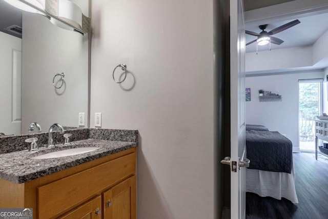 bathroom with ceiling fan, hardwood / wood-style flooring, and vanity