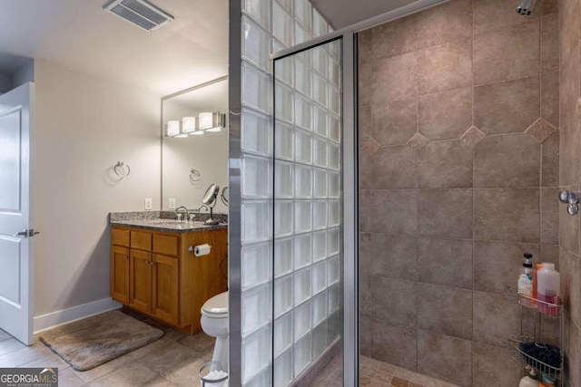 bathroom featuring walk in shower, vanity, tile patterned flooring, and toilet