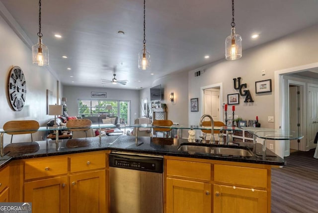 kitchen with dishwasher, sink, dark hardwood / wood-style flooring, dark stone countertops, and ceiling fan