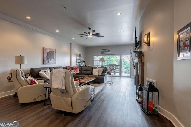 living room with ceiling fan and dark hardwood / wood-style flooring