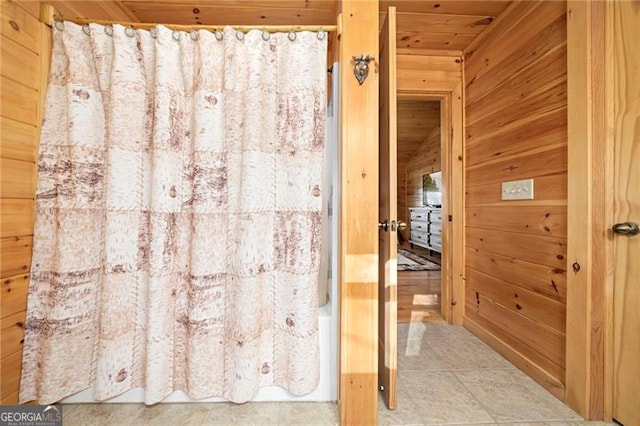 bathroom featuring wood walls