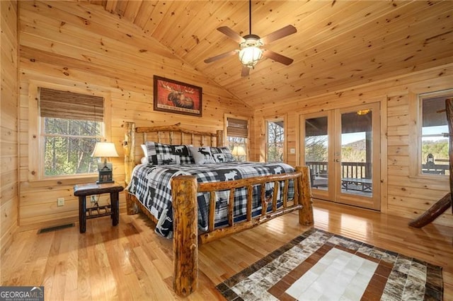 bedroom featuring access to outside, light hardwood / wood-style floors, multiple windows, and wooden ceiling