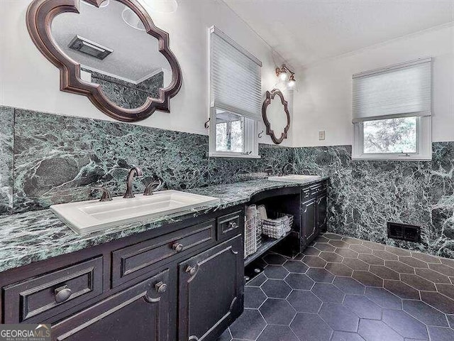 bathroom with vanity, tile walls, tile patterned floors, and a healthy amount of sunlight