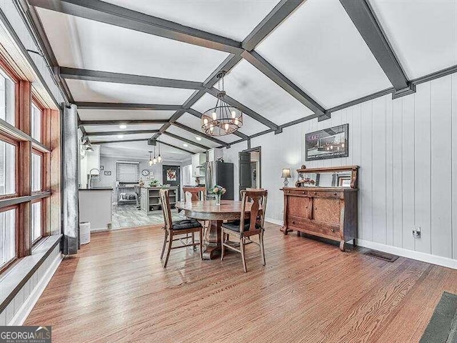 dining area with light wood-type flooring and a wealth of natural light