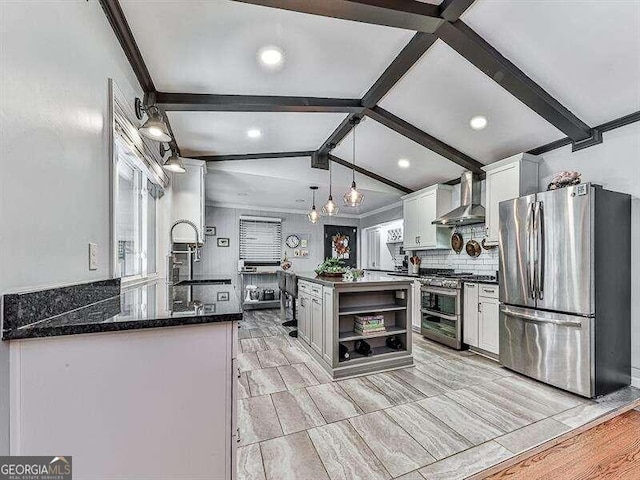 kitchen featuring white cabinetry, hanging light fixtures, wall chimney range hood, light hardwood / wood-style flooring, and stainless steel appliances