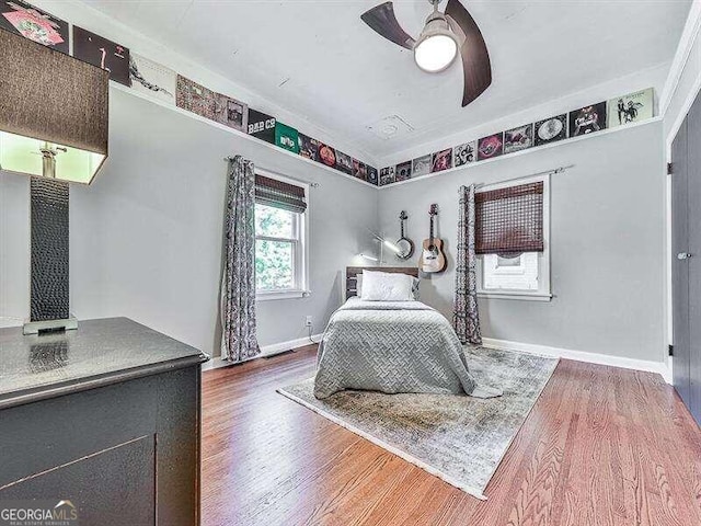 bedroom featuring dark hardwood / wood-style flooring and ceiling fan